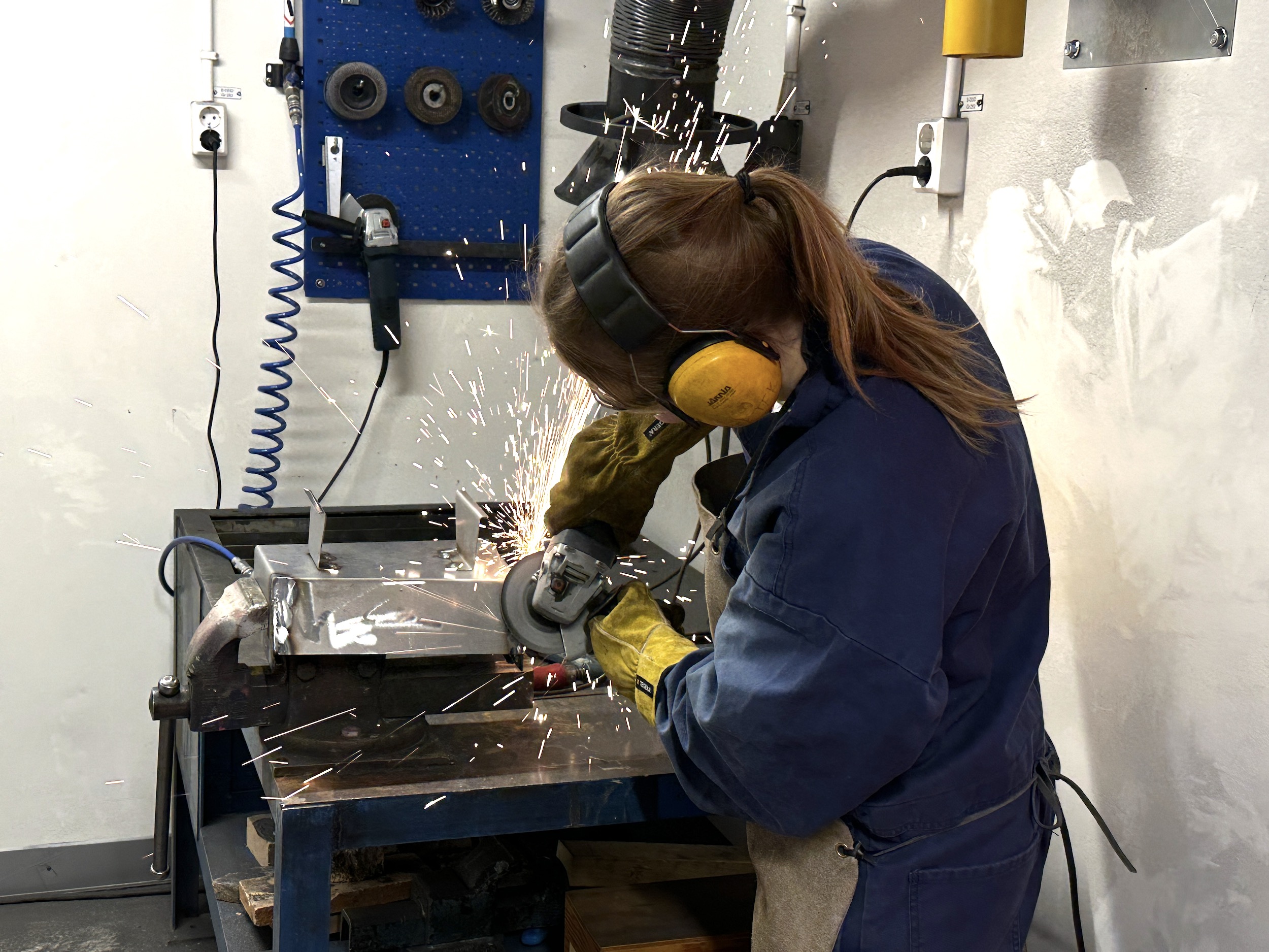 a student grinds a metal. photo.