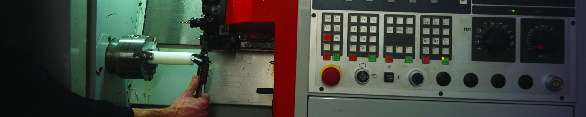 hand with calliper measures the workpiece inside CNC turning machine. photo.