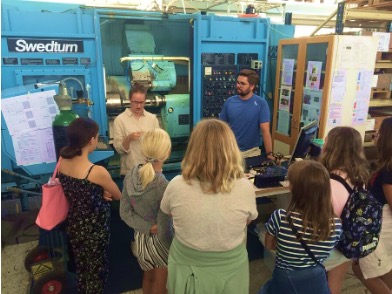 Students around urning machine. photo.